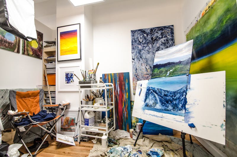 Colorful artist's studio with paints and brushes — creative cannabis strain effect for ideation