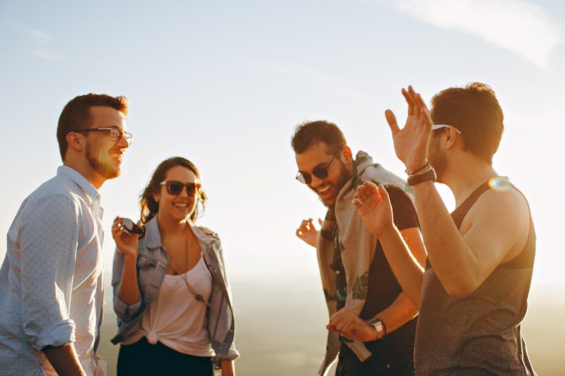 Friends enjoying outdoor sunshine — energetic sativa cannabis strain effect for daytime activity